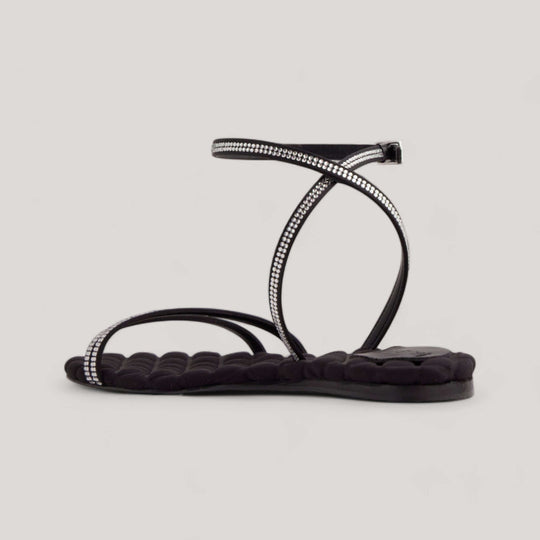 Black crystal-embellished vegan sandals with buckle-fastening ankle strap and quilted insole, luxury sustainable designer shoes, made in Italy.