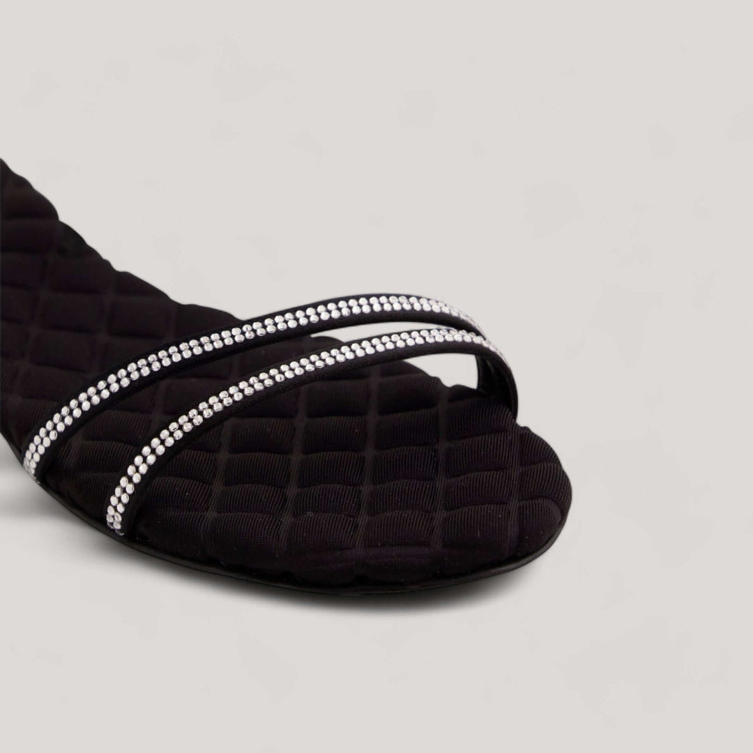 Black crystal-embellished open-toe vegan sandal with quilted insole by AERA, showcasing sustainable and minimalist design.